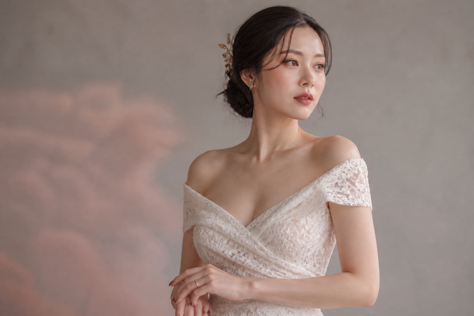 Japanese bride wearing luminous makeup, a muted berry lip and a sculptural low updo with an ivory lace gown
