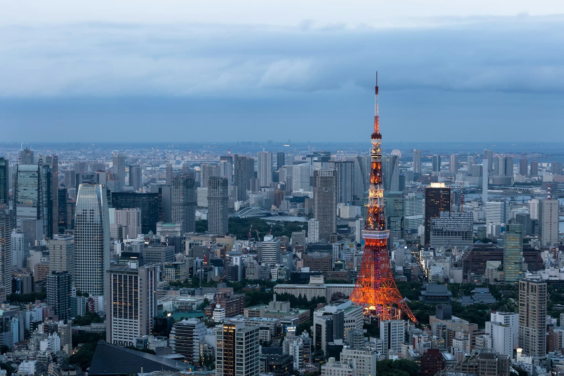 Tokyo Tower illuminated in orange above the Tokyo skyline at dusk